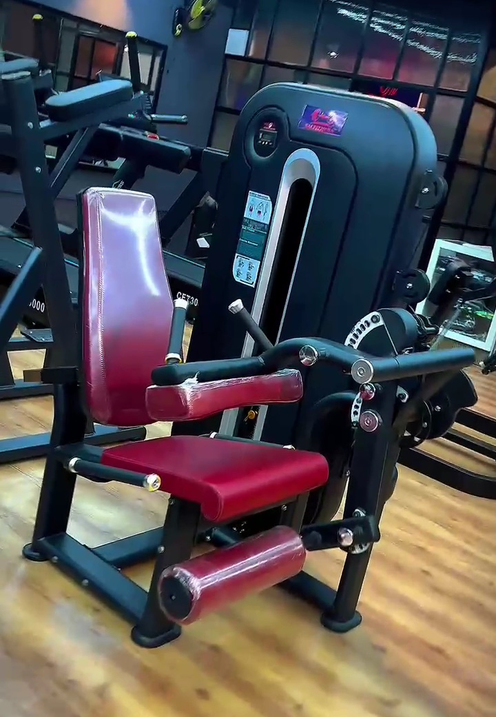 Seated leg machine with red pads at SM Fitness